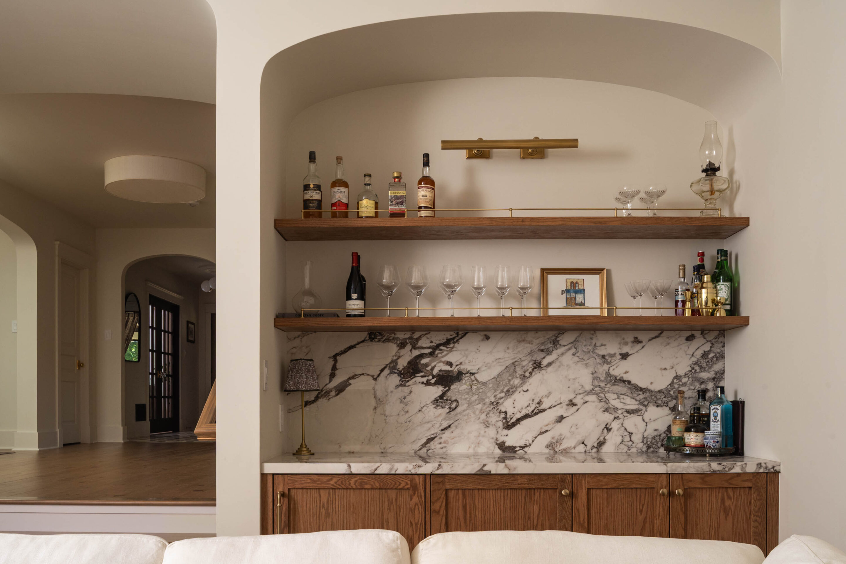 Custom wood wet bar with natural stone backsplash at Project Bellview