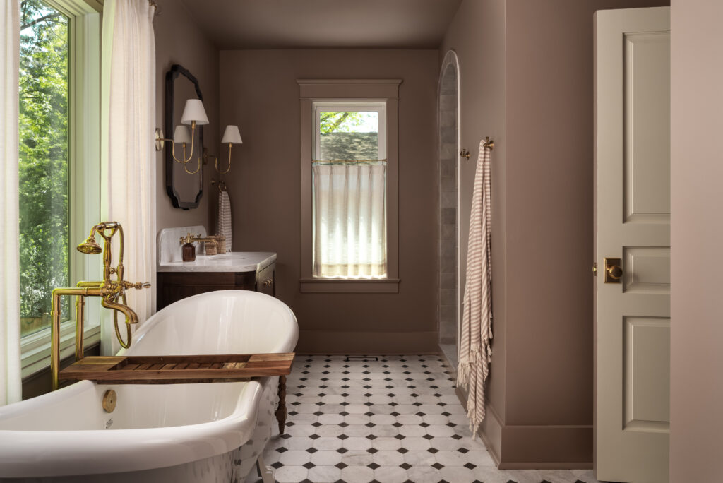 Renovated bathroom with a clawfoot tub and black-and-white tile at Project Bellview